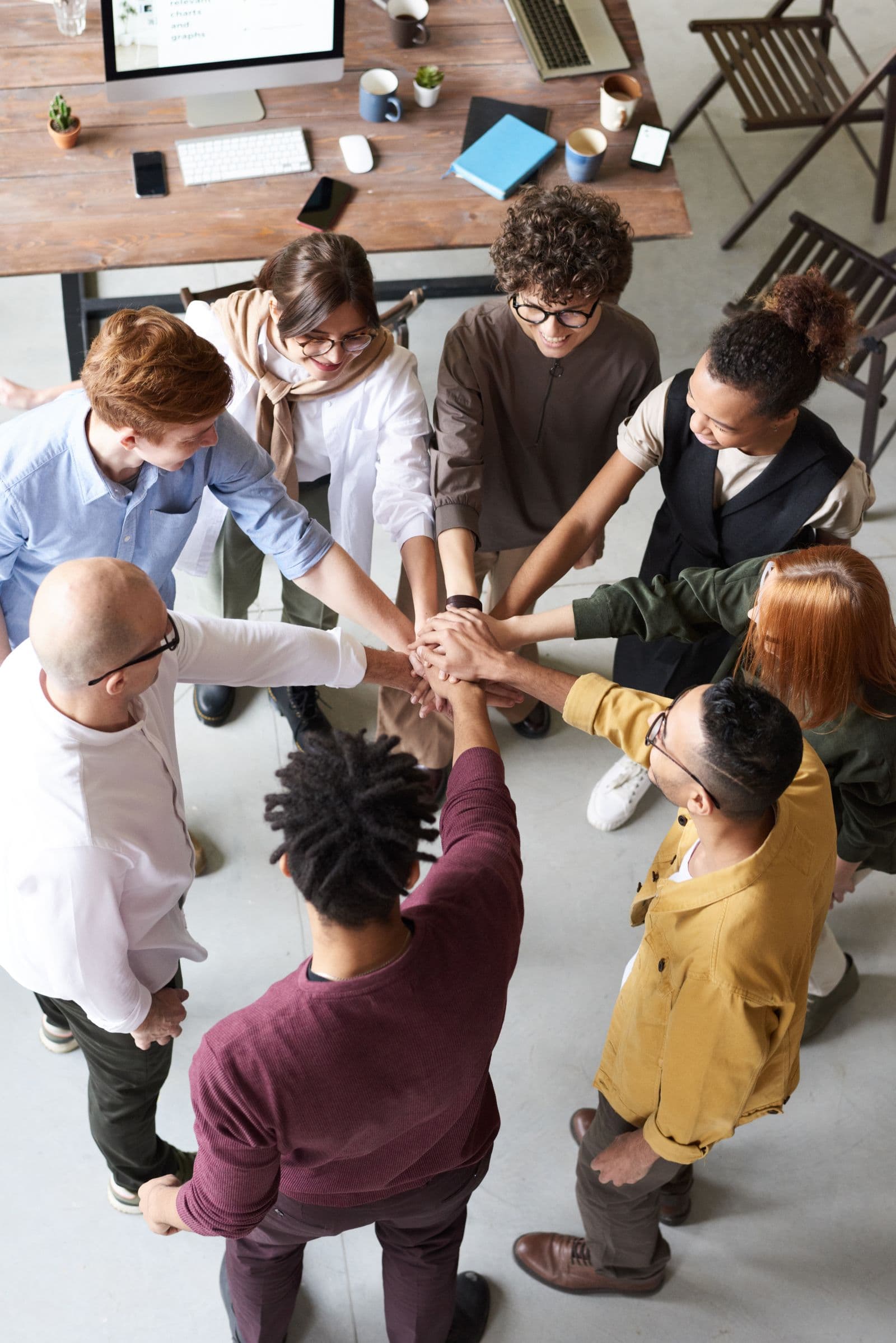 A group of people joining hands in a circle